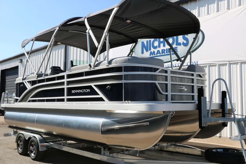 Slide: The Image of 2027 Bennington 22 SSR Tri Toon with black canopy and silver pontoons on a trailer. - 5