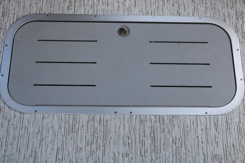 Slide: The Image of A rectangular hatch with ventilation slots on a textured floor. - 44
