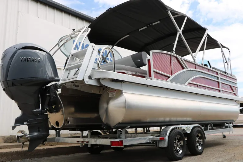 Slide: The Image of A 2027 Bennington 22 SSB Tri Toon on a trailer. It features a Yamaha outboard motor. - 24