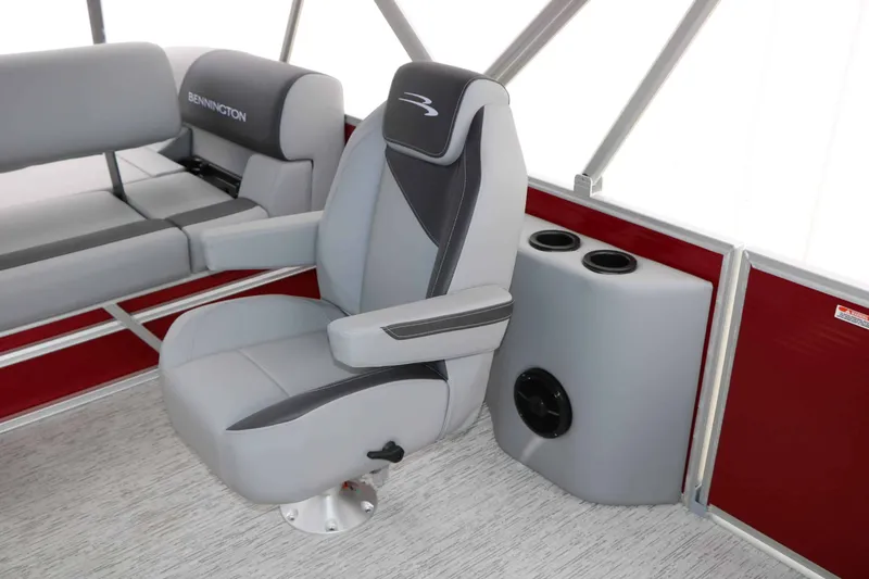 Slide: The Image of Interior of a 2027 Bennington 22 SSB Tri Toon with gray seating and red accents. - 31