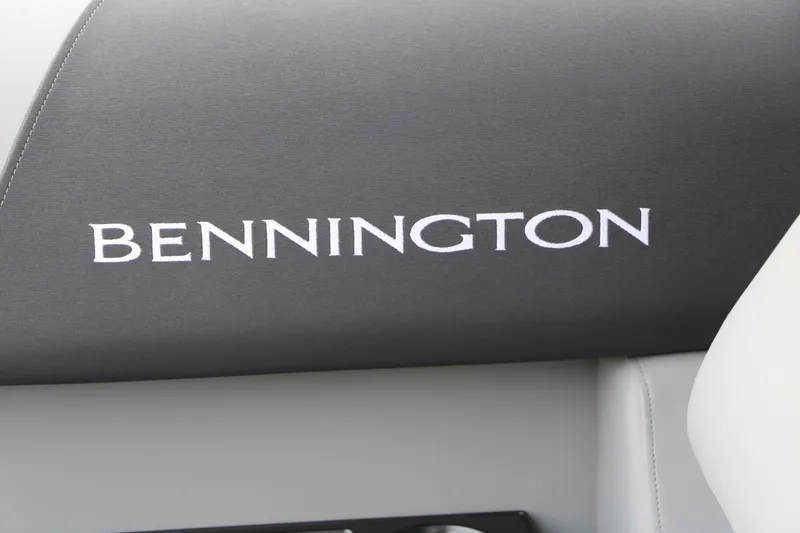 Slide: The Image of Close-up of a seat with the embroidered Bennington logo on gray fabric. - 44