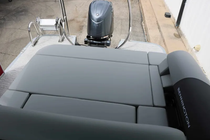 Slide: The Image of The image shows the rear of a Bennington 22 SSB Tri Toon with gray upholstery and an outboard motor. - 46