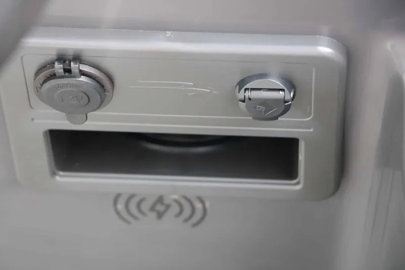 Slide: The Image of Close-up of a gray panel with a 12V socket and USB port. - 38