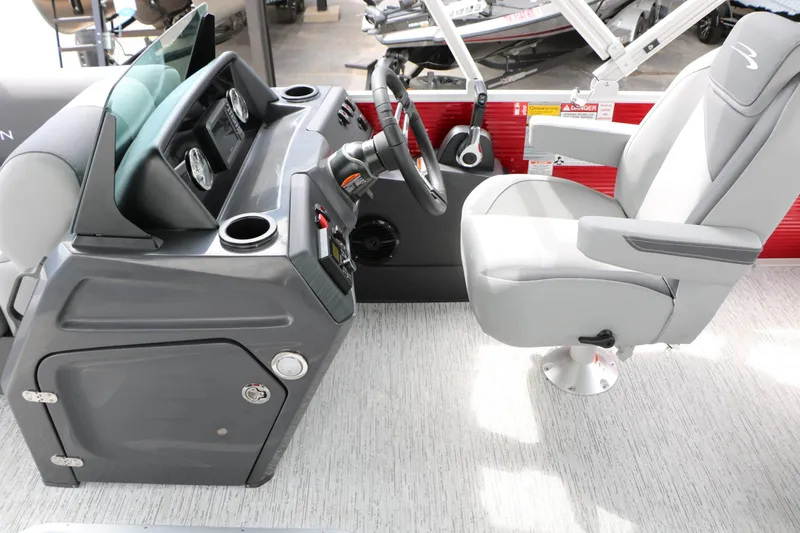 Slide: The Image of The image shows the cockpit of a 2027 Bennington 22 SSB Tri Toon with a gray dashboard and seat. - 32