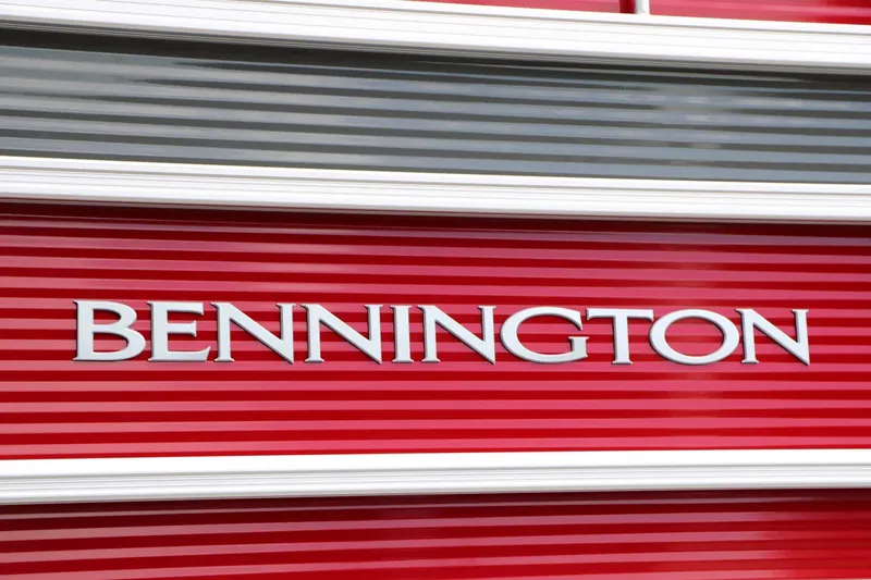 Slide: The Image of Close-up of the Bennington logo on a red and white striped boat hull. - 9