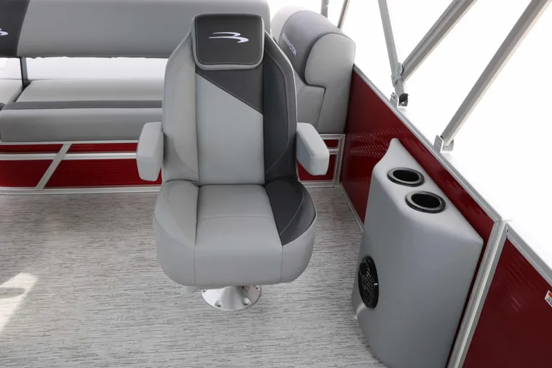 Slide: The Image of The interior of a 2027 Bennington 22 SSB Tri Toon features a gray captain's chair and red accents. - 30