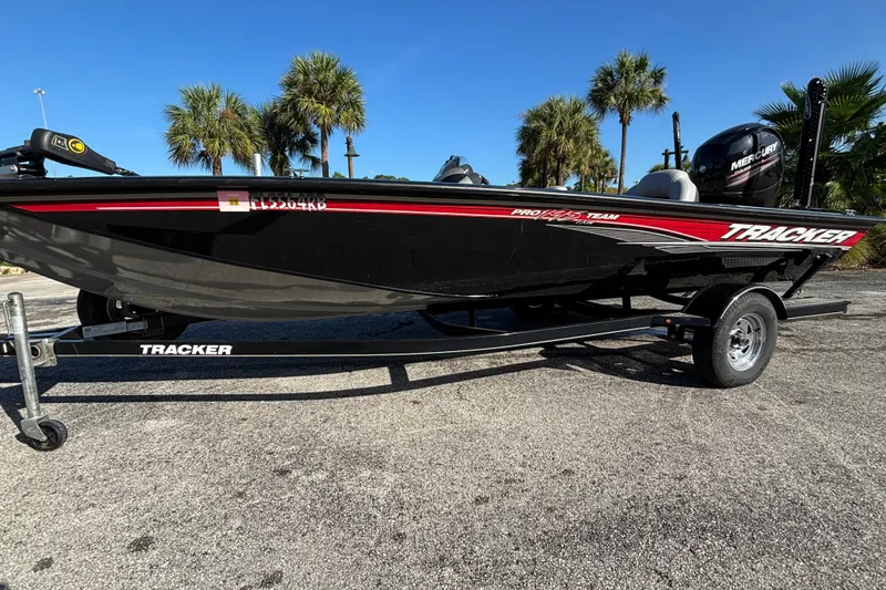 The Image of 2016 Tracker Pro Team 195 TXW Tournament Edition boat on trailer, parked outdoors. - 1
