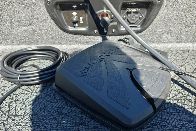 Slide: The Image of Foot pedal control on 2027 Tracker Pro Guide V-175 Combo boat, with coiled cable. - 26