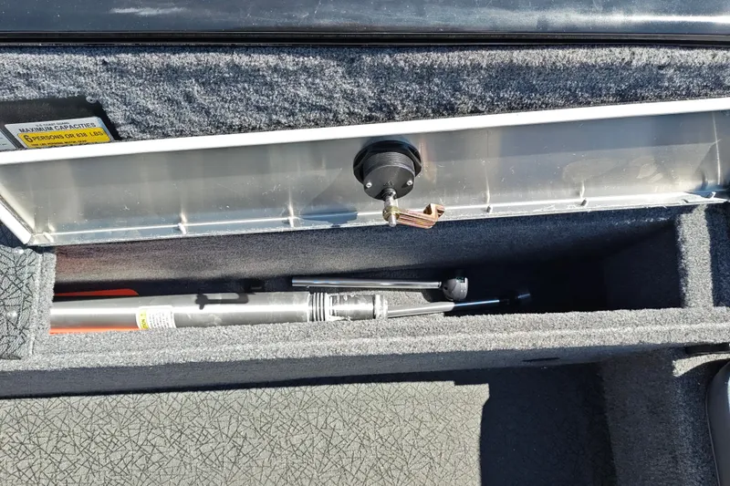 Slide: The Image of Storage compartment in 2027 Tracker Pro Guide V-175 Combo boat, showing fishing gear. - 36