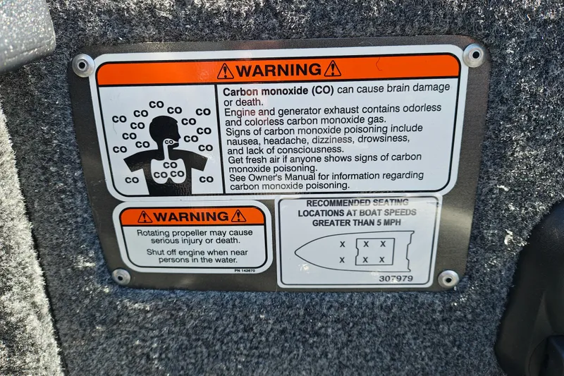 Slide: The Image of Warning labels on 2027 Tracker Pro Guide V-175 Combo boat for carbon monoxide and propeller safety. - 20