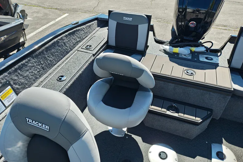 Slide: The Image of 2027 Tracker Pro Guide V-175 Combo boat interior with seating and motor. - 35