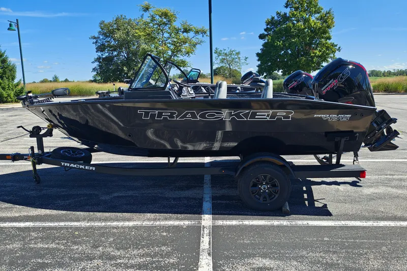 The Image of 2027 Tracker Pro Guide V-175 Combo boat on trailer in parking lot. - 1