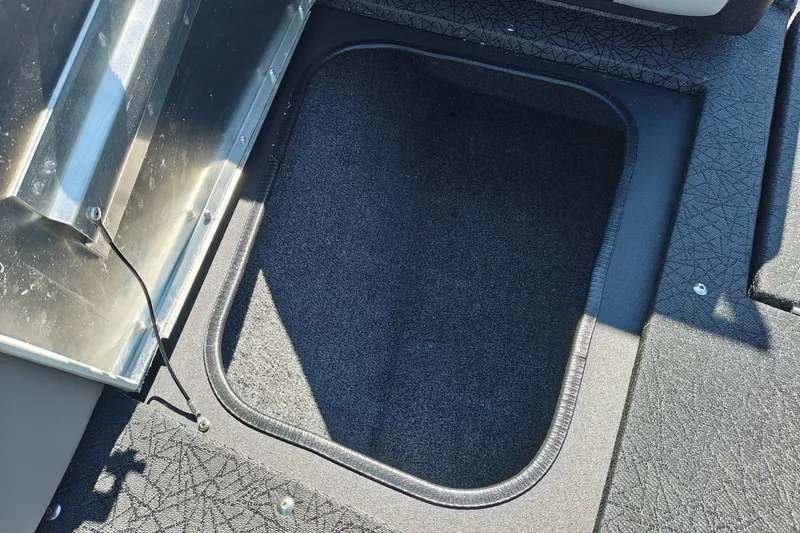Slide: The Image of 2027 Tracker Pro Guide V-175 Combo boat storage compartment, carpeted interior, open hatch. - 29
