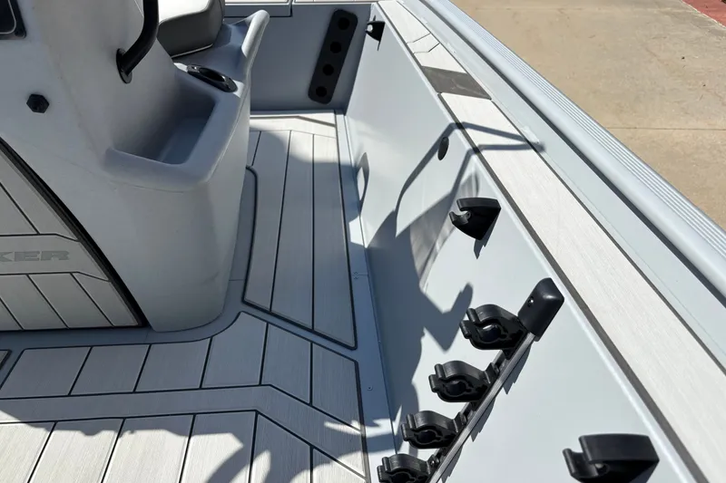 Slide: The Image of 2027 Tracker Bass Tracker Classic CC boat interior with rod holders and sleek design. - 13