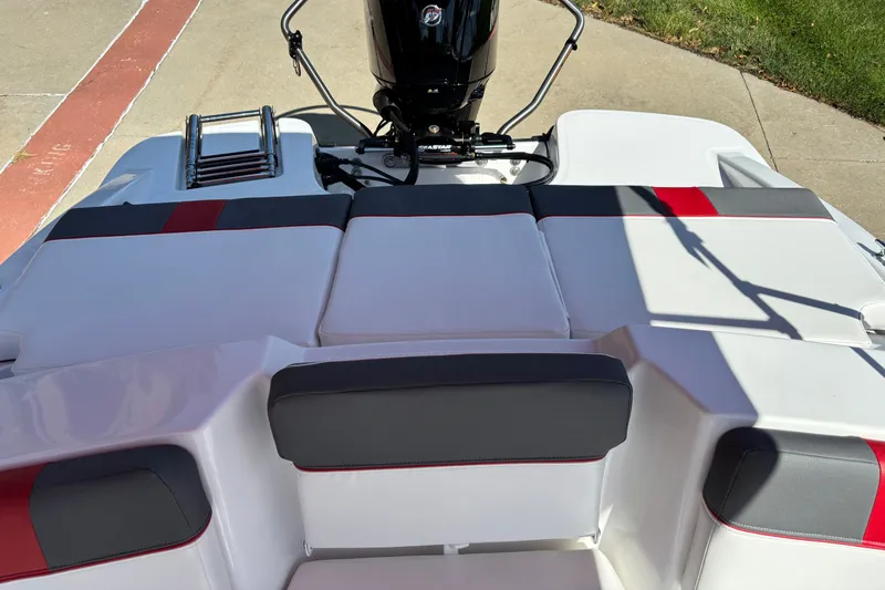 Slide: The Image of 2027 Tahoe T16 boat with cushioned seating and outboard motor, docked on concrete. - 5