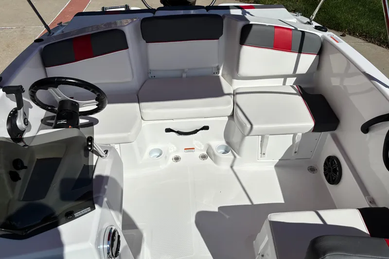 Slide: The Image of Interior of 2027 Tahoe T16 boat with white and red seating, steering wheel, and controls. - 4