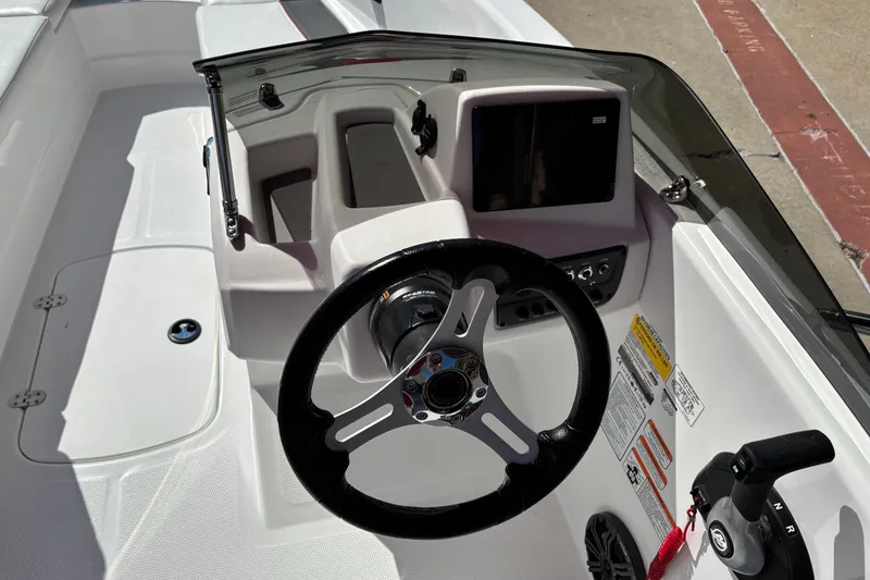 Slide: The Image of 2027 Tahoe T16 boat cockpit with steering wheel and control panel. - 6