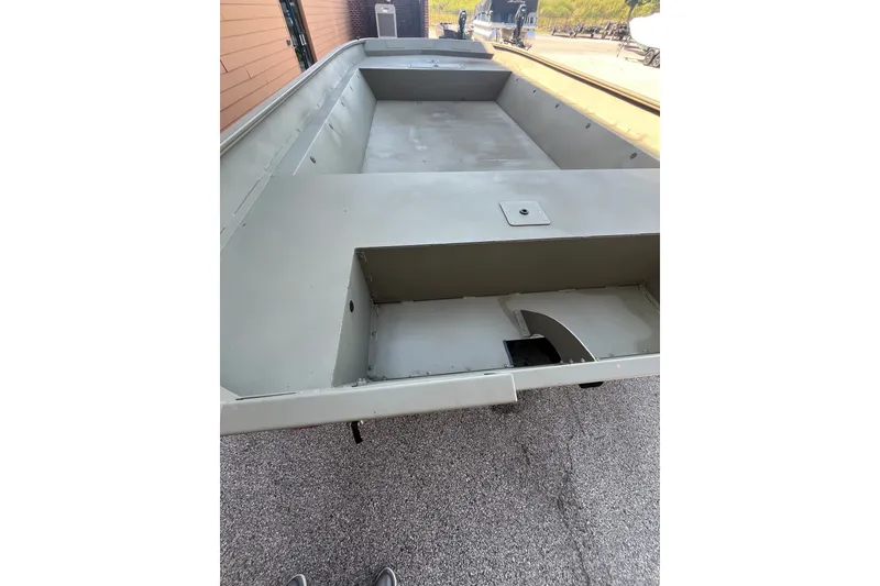 Slide: The Image of 2026 Tracker Grizzly 2072 Utility boat, empty interior view, parked outdoors. - 20