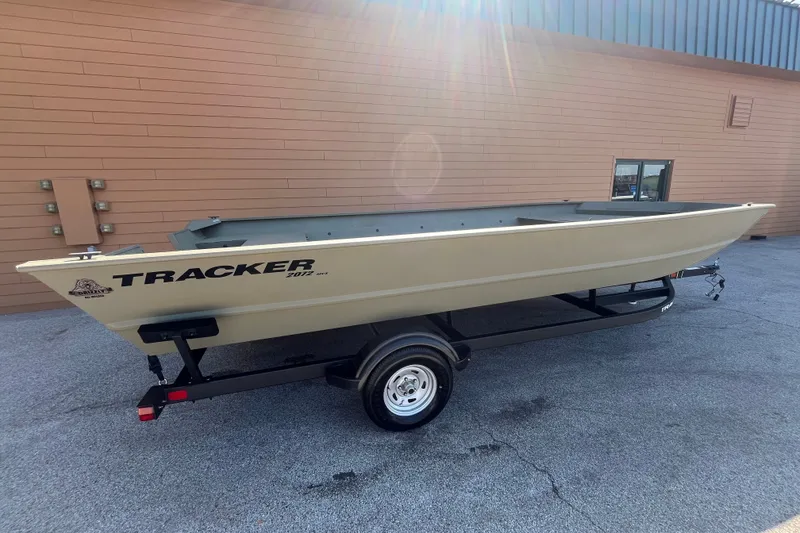 The Image of 2026 Tracker Grizzly 2072 Utility boat on trailer, parked outdoors in sunlight. - 0