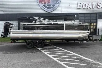 The Image of A 2027 Sun Tracker Fishin' Barge 22 DLX on a trailer in front of a building. - 0