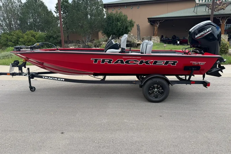 The Image of Red 2027 Tracker Pro Team 175 Crappie Edition boat on trailer, parked outdoors. - 0