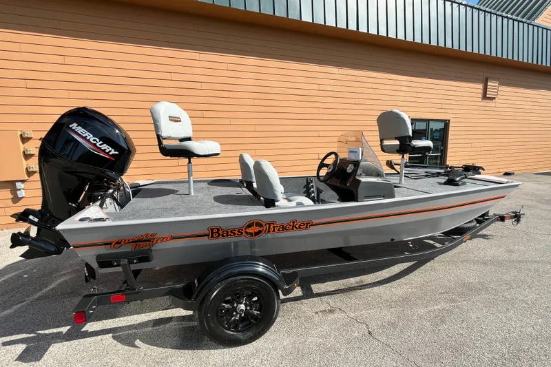 The Image of 2027 Tracker Bass Tracker Classic Limited boat with Mercury engine, parked outdoors. - 0