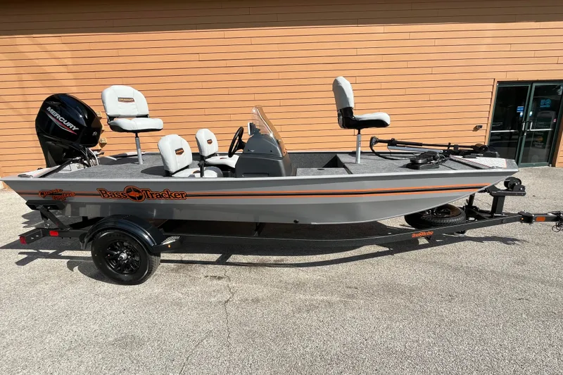The Image of 2027 Tracker Bass Tracker Classic Limited fishing boat on trailer, parked outdoors. - 0