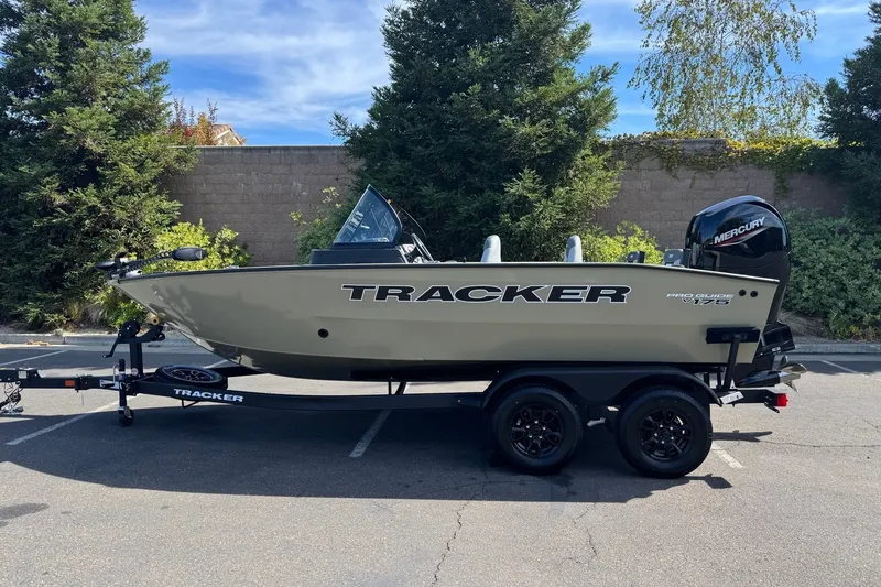The Image of 2027 Tracker Pro Guide V-175 Combo boat on trailer, parked outdoors. - 0