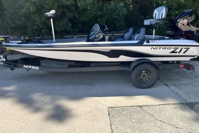 The Image of 2027 Nitro Z17 fishing boat on trailer, sleek design, parked outdoors. - 0