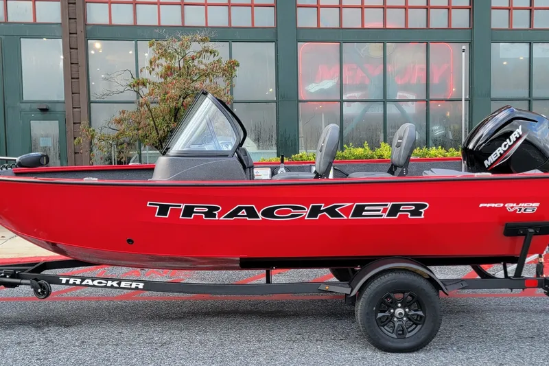 The Image of Red 2026 Tracker Pro Guide V-16 WT boat with Mercury engine on trailer. - 0