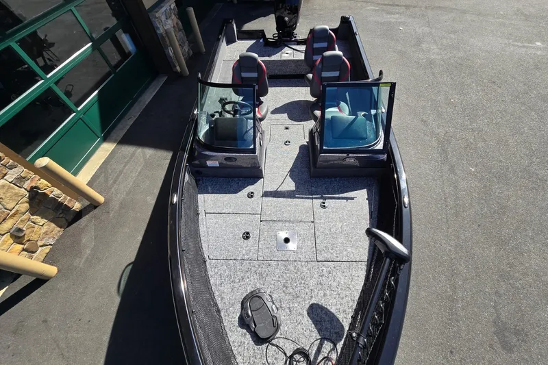 Slide: The Image of 2026 Ranger VS1882SC Angler boat with dual seats and windshield, parked outdoors. - 2