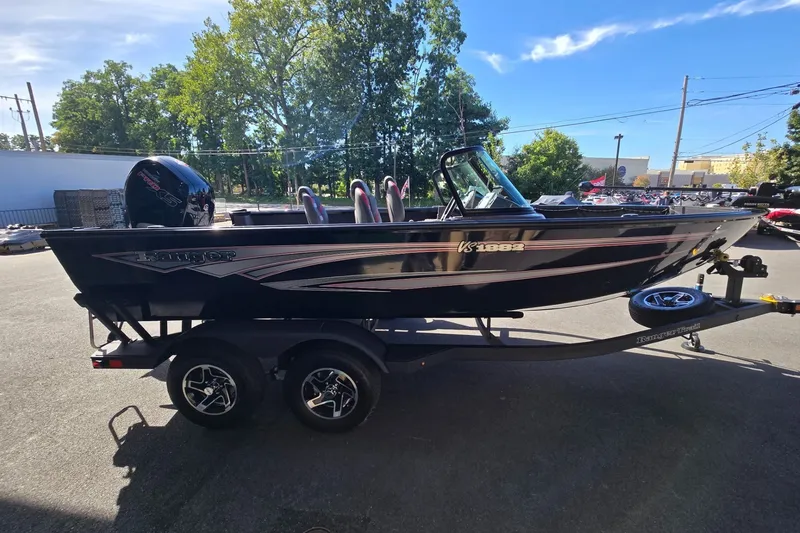 Slide: The Image of 2026 Ranger VS1882SC Angler boat on trailer, parked outdoors, with trees in the background. - 1