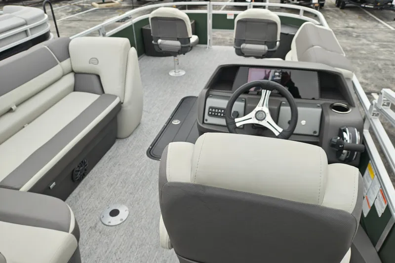 Slide: The Image of 2027 Sun Tracker Fishin' Barge 22 XP3 interior with steering wheel and seating. - 43