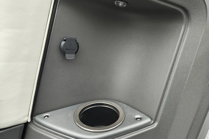 Slide: The Image of Cup holder and USB port on 2027 Sun Tracker Fishin' Barge 22 XP3 boat interior. - 22
