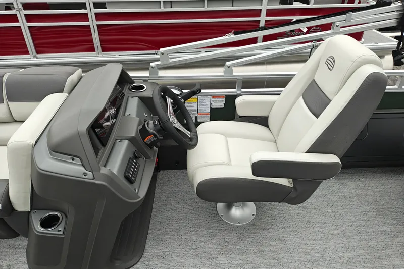 Slide: The Image of 2027 Sun Tracker Fishin' Barge 22 XP3 helm with plush captain's chair and modern dashboard. - 21