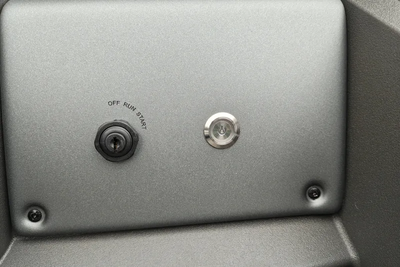 Slide: The Image of Control panel of 2027 Sun Tracker Fishin' Barge 22 XP3 with ignition switch and power button. - 25