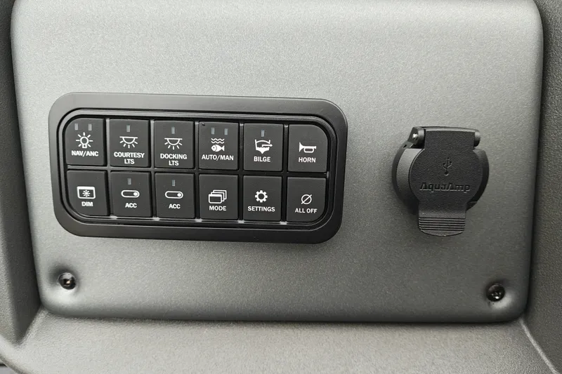 Slide: The Image of Control panel of 2027 Sun Tracker Fishin' Barge 22 XP3 with various function buttons. - 24