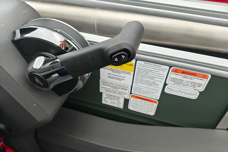 Slide: The Image of Throttle control and safety labels on 2027 Sun Tracker Fishin' Barge 22 XP3 boat. - 26