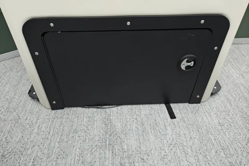 Slide: The Image of 2027 Sun Tracker Fishin' Barge 22 XP3 storage compartment with black panel and lock. - 33