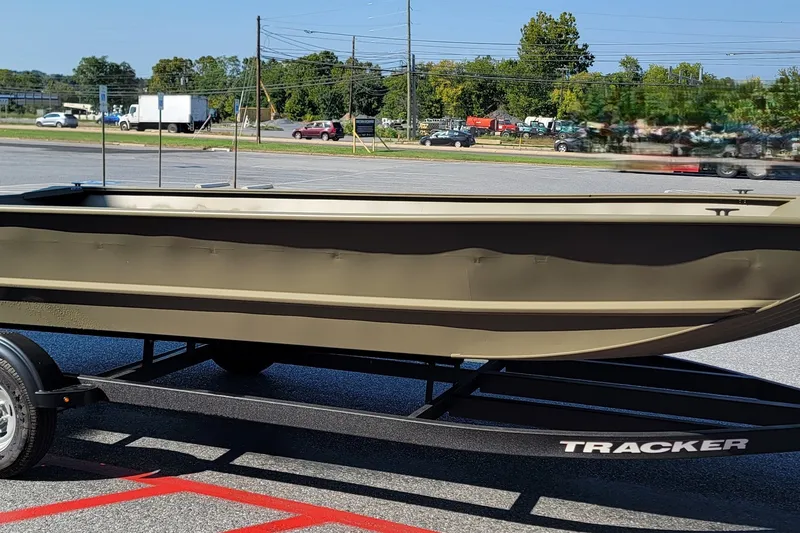 The Image of 2026 Tracker Grizzly 2072 Utility boat on trailer in parking lot. - 0
