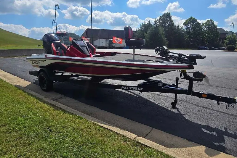 The Image of 2027 Nitro Z18 XL Pro fishing boat on trailer in sunny parking lot. - 0
