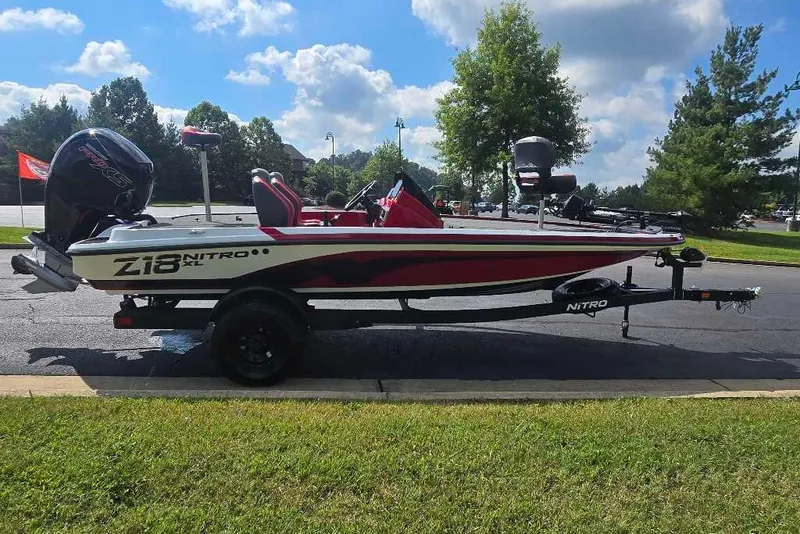 The Image of 2027 Nitro Z18 XL Pro boat on trailer, parked outdoors under a cloudy sky. - 0