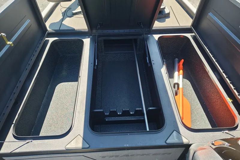 Slide: The Image of Open storage compartments on a 2027 Tracker Pro 170 boat, featuring paddles and ample space. - 20