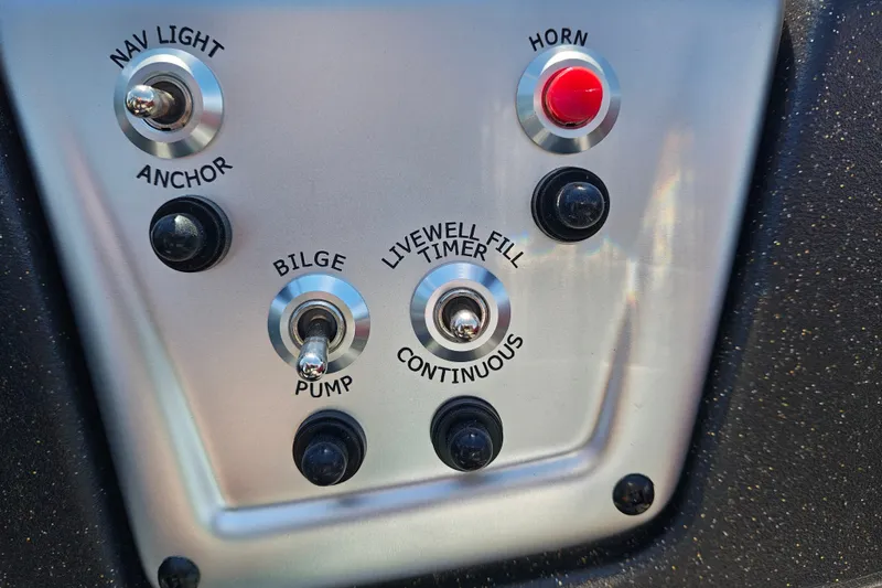 Slide: The Image of Control panel of 2027 Tracker Pro 170 boat with switches and buttons. - 15