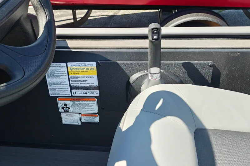 Slide: The Image of Interior of a 2027 Tracker Pro 170 boat showing steering wheel and capacity labels. - 17