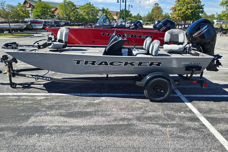 The Image of 2027 Tracker Pro 170 boat on trailer in parking lot, sunny day. - 1