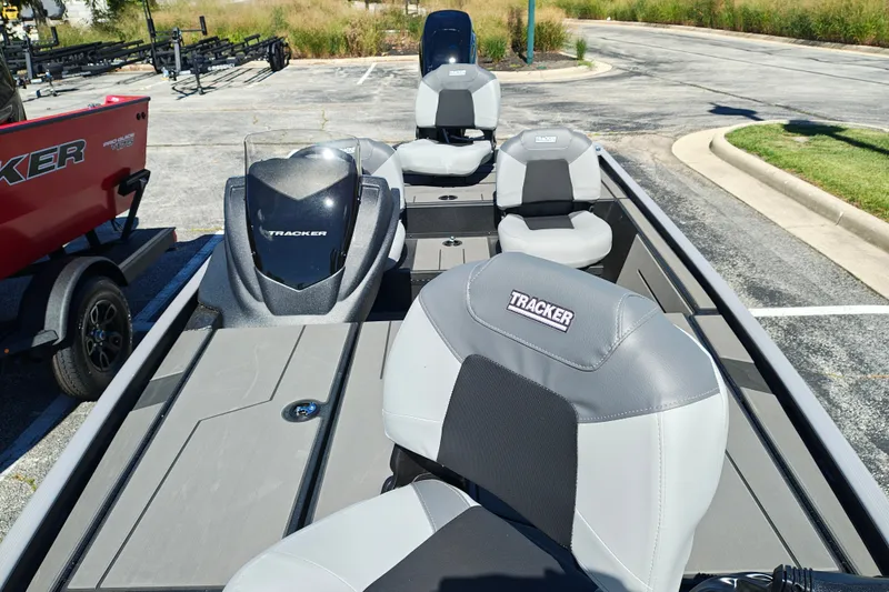Slide: The Image of 2027 Tracker Pro 170 boat with gray seating and sleek design in a parking lot. - 23