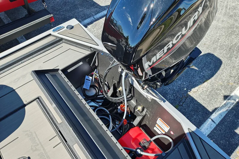 Slide: The Image of Tracker Pro 170 boat with Mercury engine, showcasing storage compartment and wiring, 2027 model. - 28