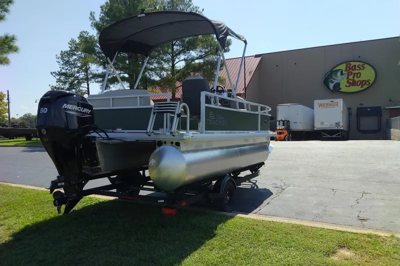 Slide: The Image of 2027 Sun Tracker Bass Buggy 16 XL Select pontoon boat outside Bass Pro Shops. - 76