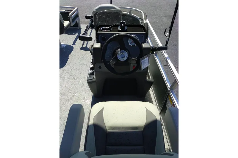 Slide: The Image of 2027 Sun Tracker Bass Buggy 16 XL Select boat interior with steering wheel and seating. - 16